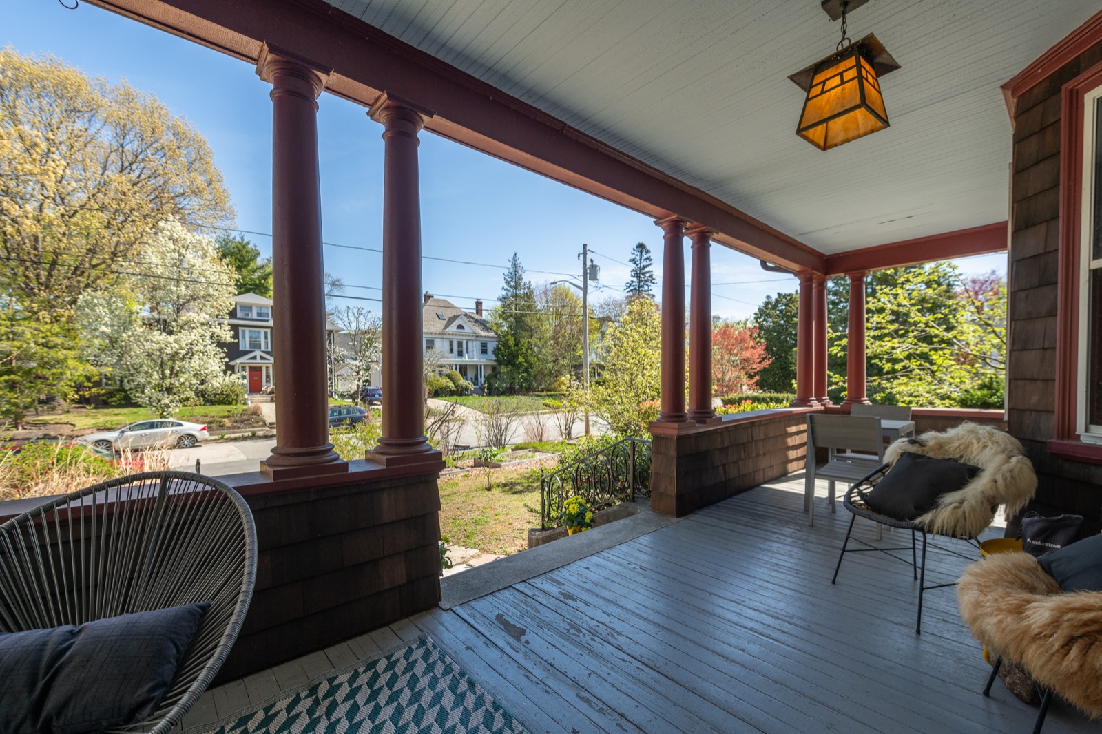The covered wraparound porch with Mission lantern and column detail.