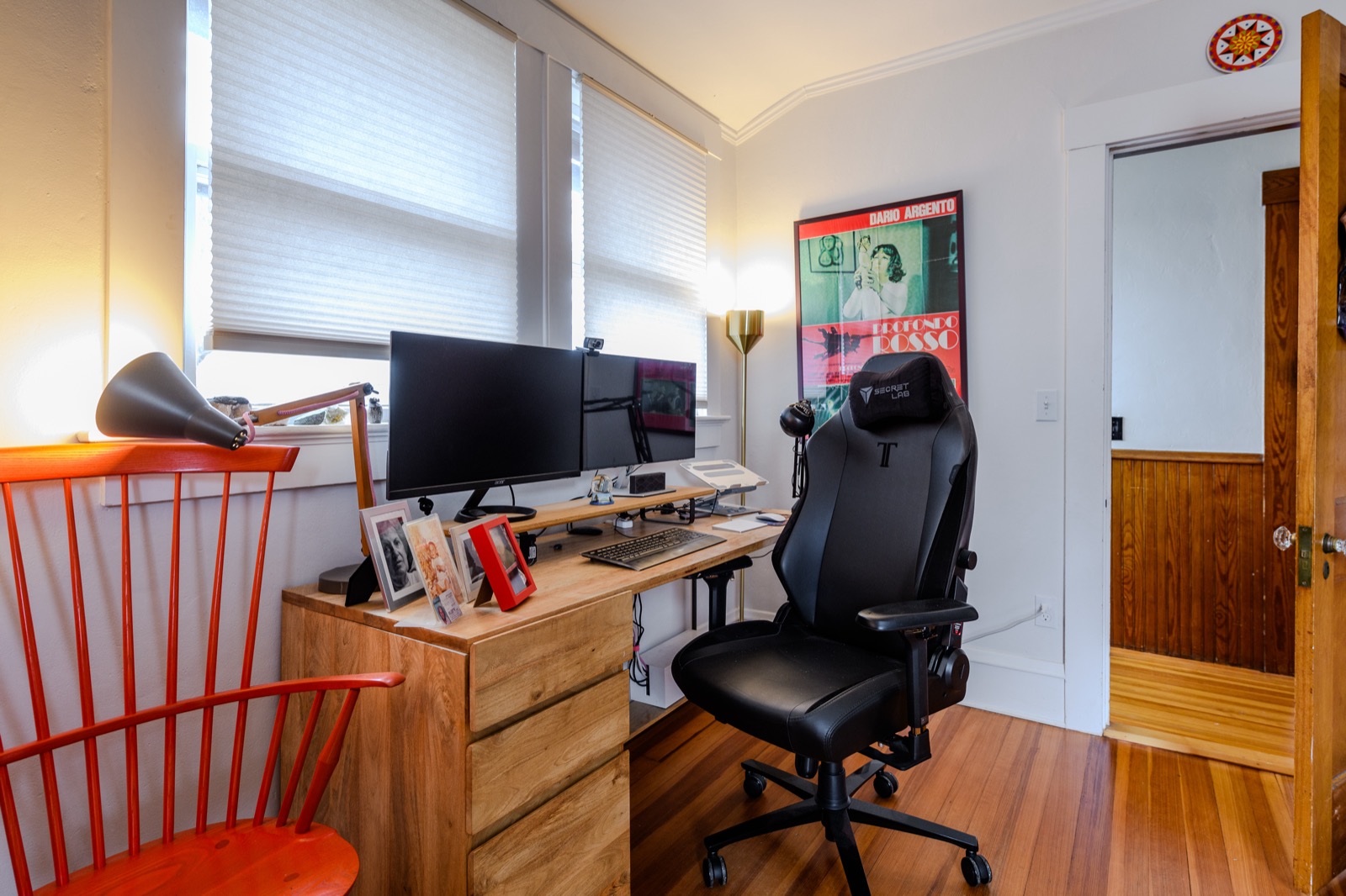 Second home office set up with dual monitors, ergonomic chair, and natural light.
